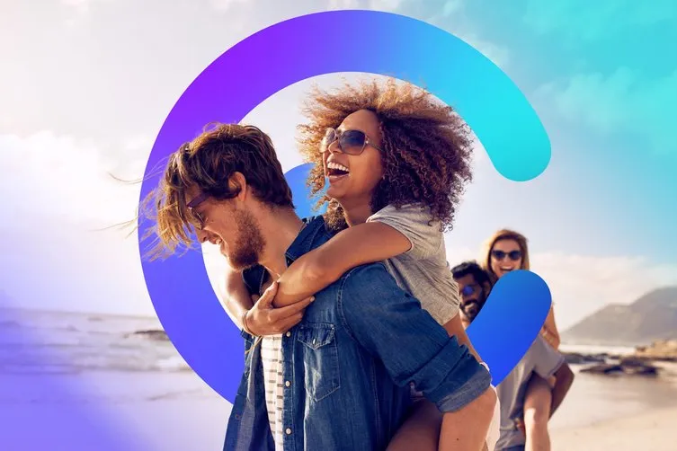 A young couple laughing on the beach, framed by the Catilize C