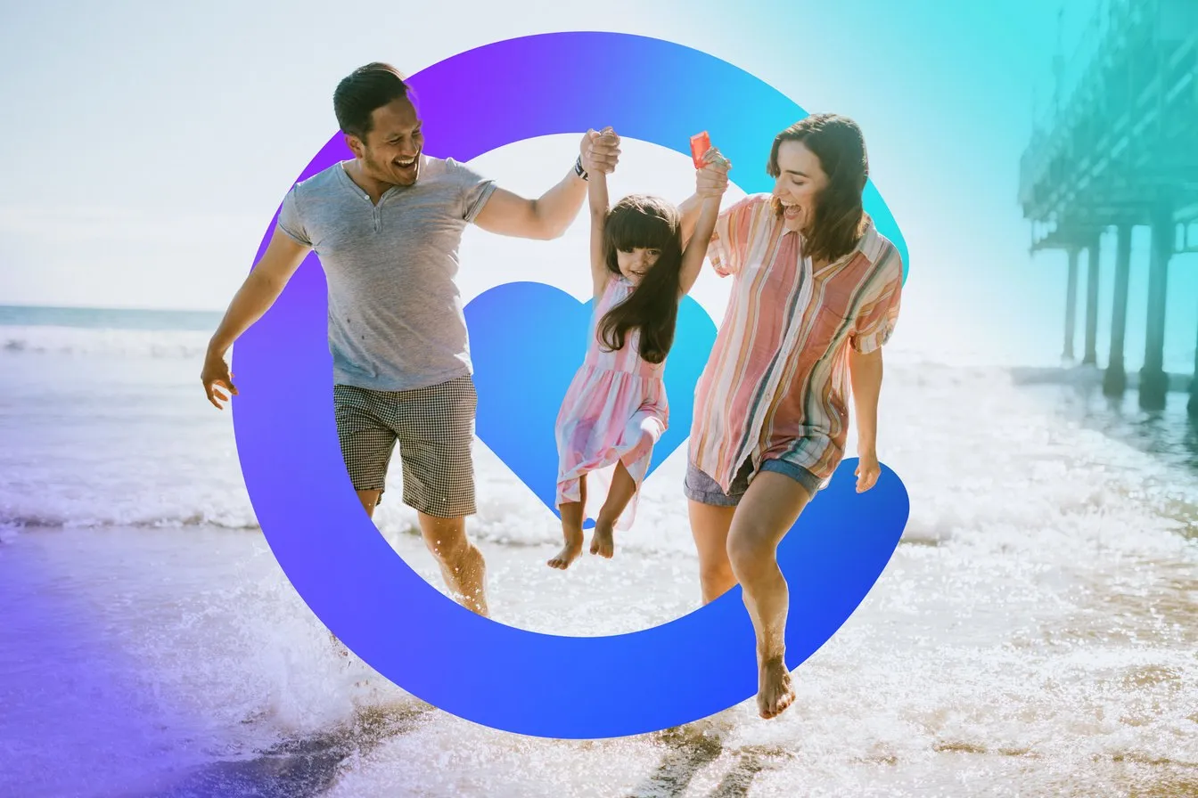 A young family swinging their daughter over the surf on a bright beach, framed by the Catilize C