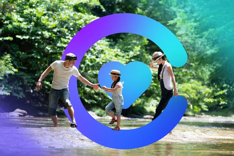 A family wading through a creek together, framed by the Catilize C