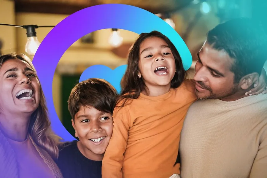 A family laughing together under string lights, framed by the Catilize C